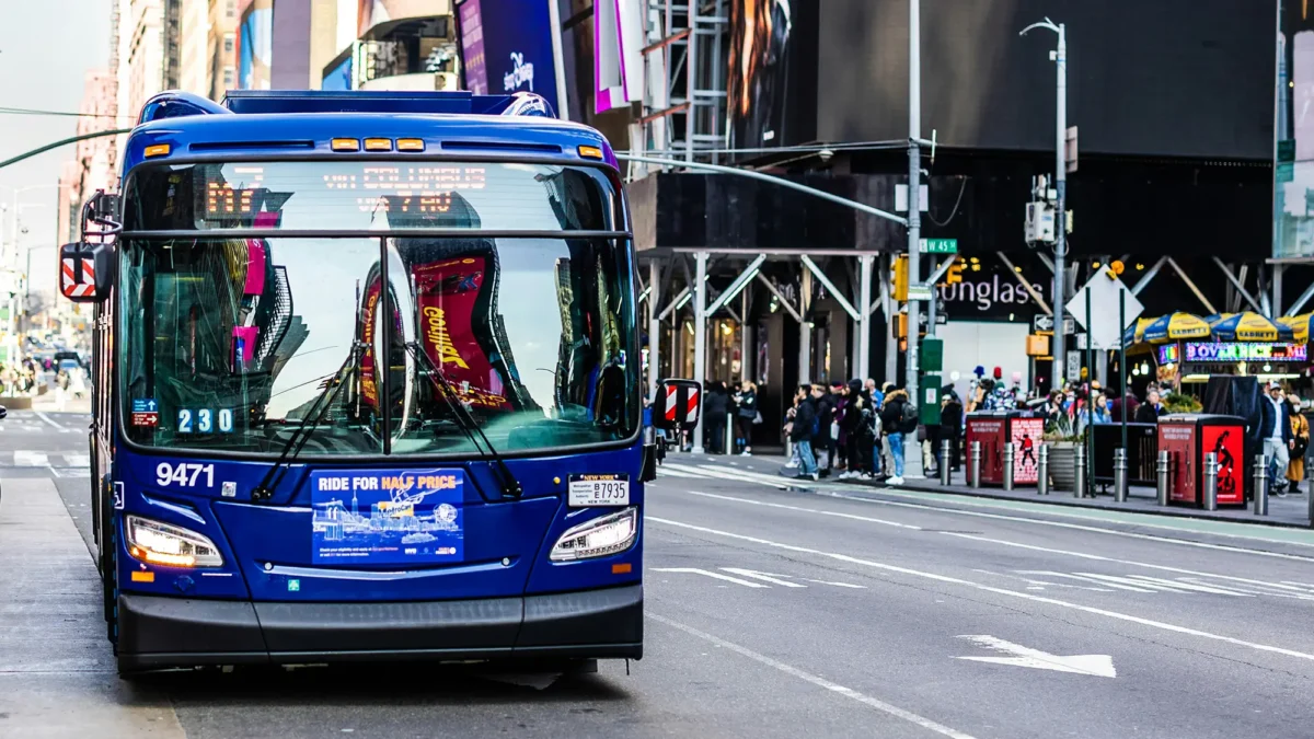 Blue bus rolling through Times Square